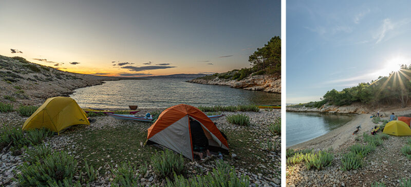 Camping by a rocky lakeshore at sunset with yellow and orange tents and small boats on the shore.